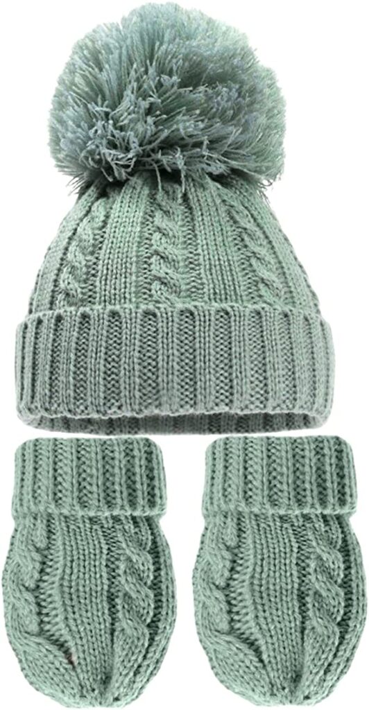 A green knitted newborn and hat and mittens set