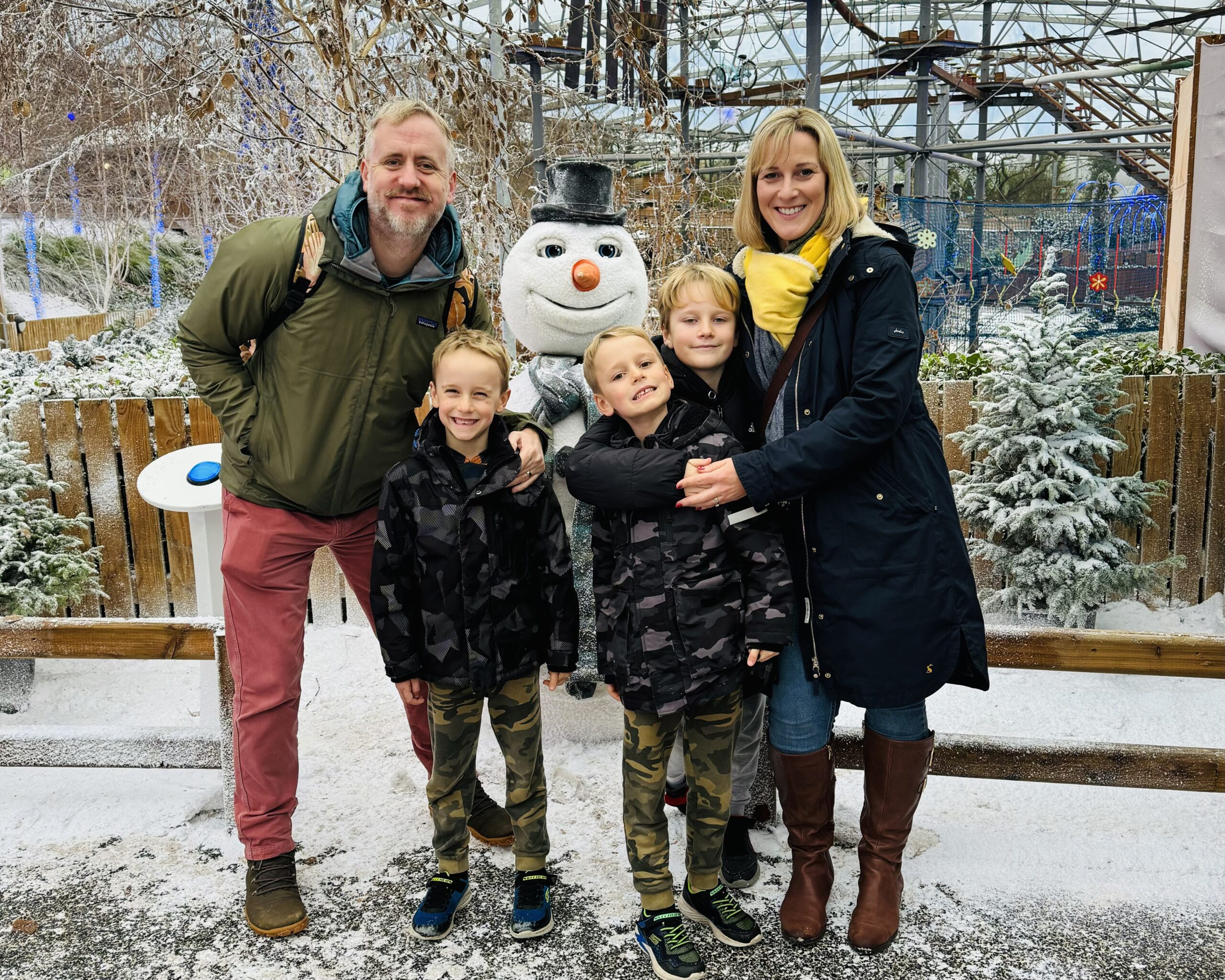 A family next to the singing snowman at Bluestone