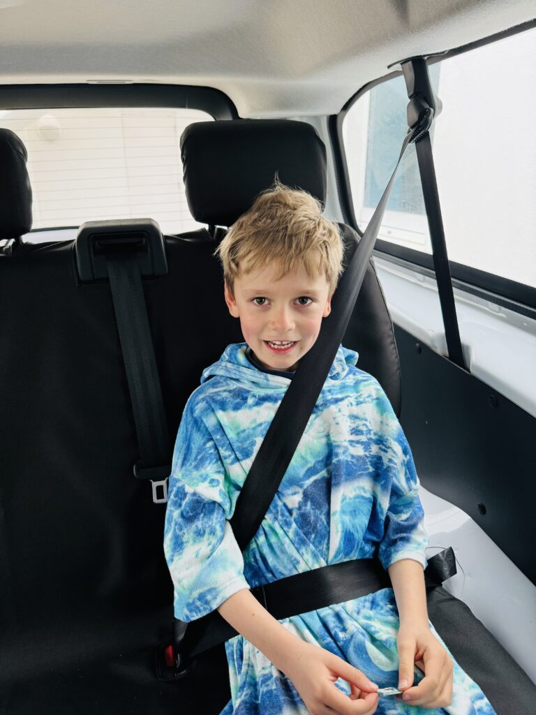 6 year old boy in the back of a minibus at the St Moritz Hotel in Cornwall