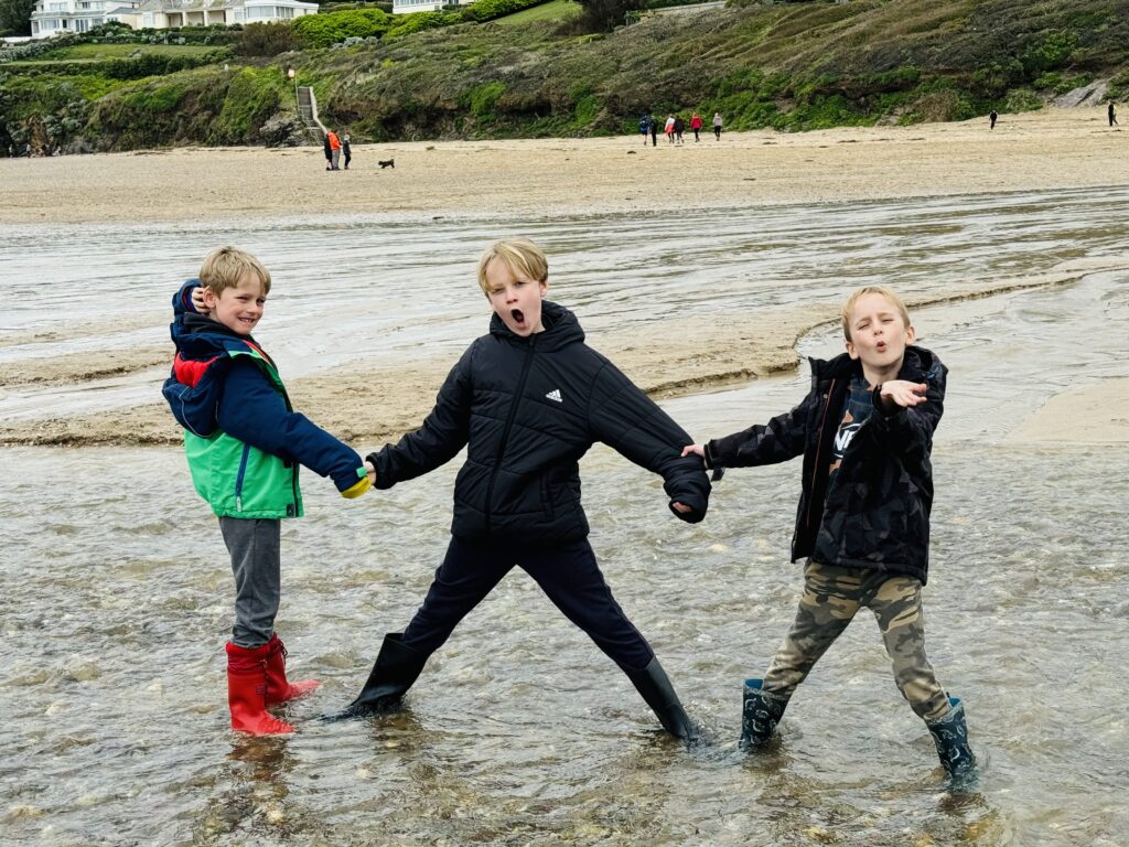 Three boys on Polzeath beach