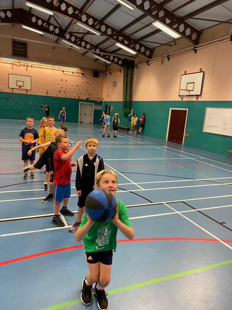 Kids shooting at High 5 slam dunk basketball camp