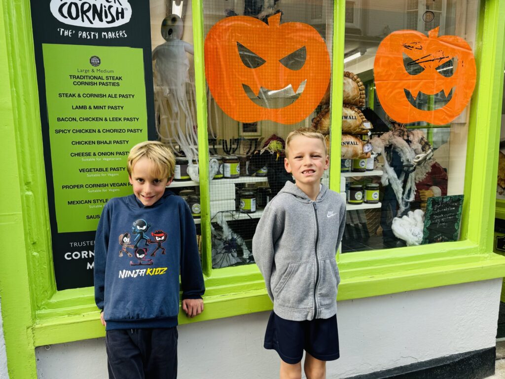 Twin brothers outside a shop with Halloween decorations on Plymouth Barbican