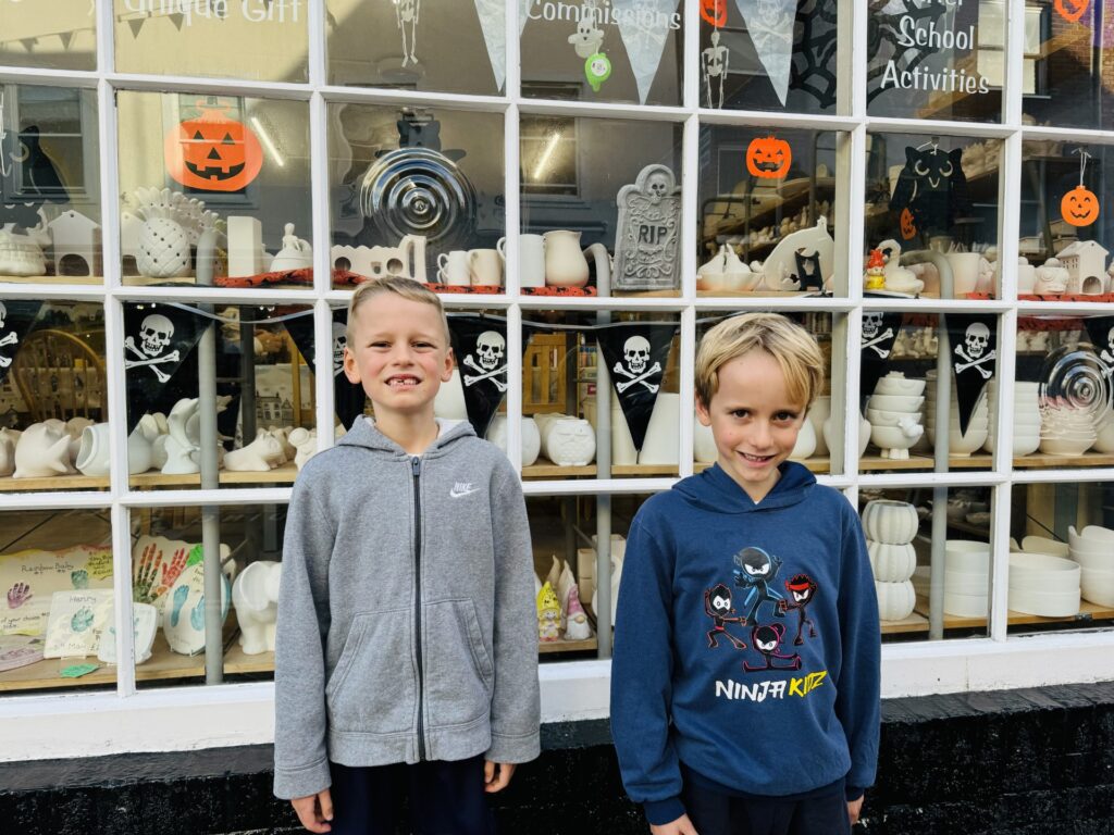 Twin brothers outside a shop with Halloween decorations on Plymouth Barbican