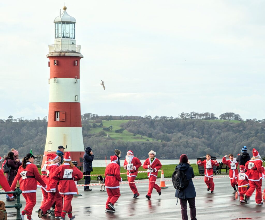 Runners on Plymouth Hoe taking part in the Santa Fun Run