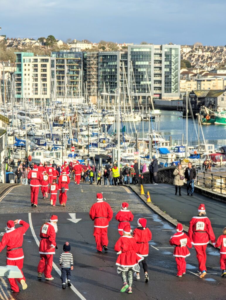 Runners on Plymouth's Barbican during the Santa Fun Run