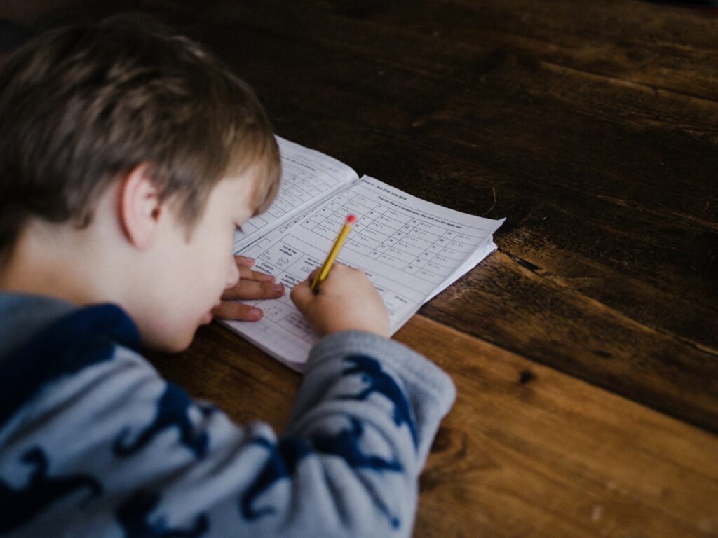 a boy using his focus on a bit of paper